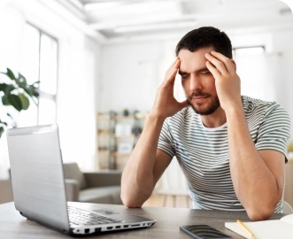 Photo of a man using a laptop